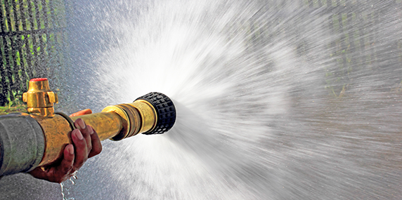 Image of a fire hose spraying water